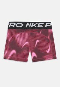 Ružové a hnedočervené kompresné šortky so vzorom a čiernym pásom, na ktorom je v bielej farbe napísané "PRO NIKE". Hladká textúra, športový dizajn.