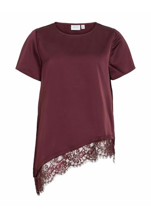 Lyhythihainen, tummanvioletti pusero, jossa epäsymmetrinen helma ja yksityiskohtainen kukkakuvioinen pitsireunus alareunassa.