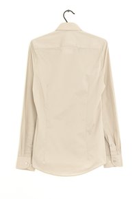 Chemise à manches longues en tissu beige clair. Dotée d'un col classique, d'un ourlet arrondi et de détails en bouton aux poignets et au dos. Texture lisse.