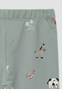 Katoenen leggings in gedempt groen met een elastische tailleband en geborduurde patronen van boerderijdieren en bloemen in roze, wit en bruin.