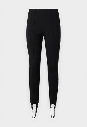 Leggings negri cu un design elegant, având detalii de cusătură proeminente și deschideri la glezne cu accente moale sub formă de bucle. Fabricate dintr-un material elastic.
