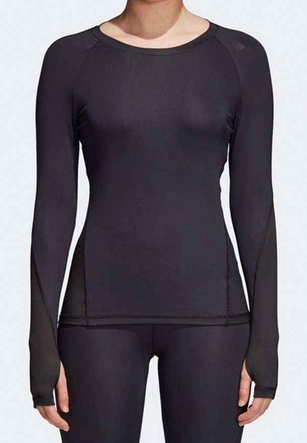 Svart långärmad träningsöverdel av elastiskt tyg, med raglanärmar och tumhål i ärmsluten för extra skydd.