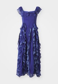 Vestido púrpura con lunares, con volantes en capas, mangas cortas y una silueta fluida, que presenta una mezcla de texturas de tela transparentes y sólidas.