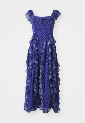 Purple polka dot dress with layered ruffles, short sleeves, and a flowing silhouette, featuring a mix of sheer and solid fabric textures.