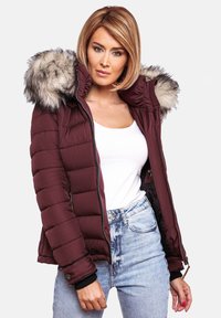 Maroon puffer jacket with a faux fur hood, zip closure, ribbed cuffs, and quilted texture. Worn over a white tank and high-waisted jeans.