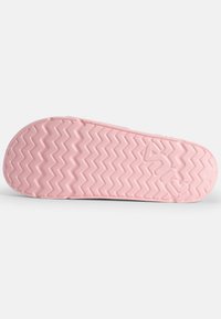 Rosa gummisole med ett zigzag-mönster och präglad logotyp. Slät textur med rundade kanter, utformad för grepp.