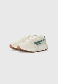 White sneakers with green accents, composed of textured fabric and smooth leather. Features a chunky sole and lace-up design.