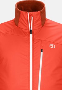 Red insulated jacket with a high collar, featuring a contrasting brown inner collar, zippered front, and side pockets with white zippers.