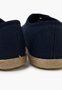Námořnické plátěné espadrilky s tkanou texturou a přirozenou jutovou podrážkou. Kulatý design se šitým okrajem, s měkkou vnitřní podšívkou.