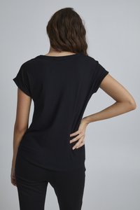 Schwarzes T-Shirt mit kurzen Ärmeln und Rundhalsausschnitt, aus weichem Stoff und mit lockerer Passform. Der Rücken hat einen dezenten, abgerundeten Saum.