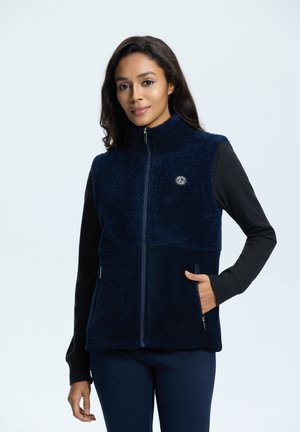 Chaleco de forro polar azul marino con cuello alto, frente con cremallera, dos bolsillos laterales y un logo en el pecho; material texturizado y suave.