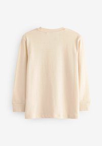 Lichtbeige langemouwen shirt gemaakt van zachte katoen. Heeft een ronde hals, ribgebreide manchetten en een gladde textuur zonder patronen of accenten.