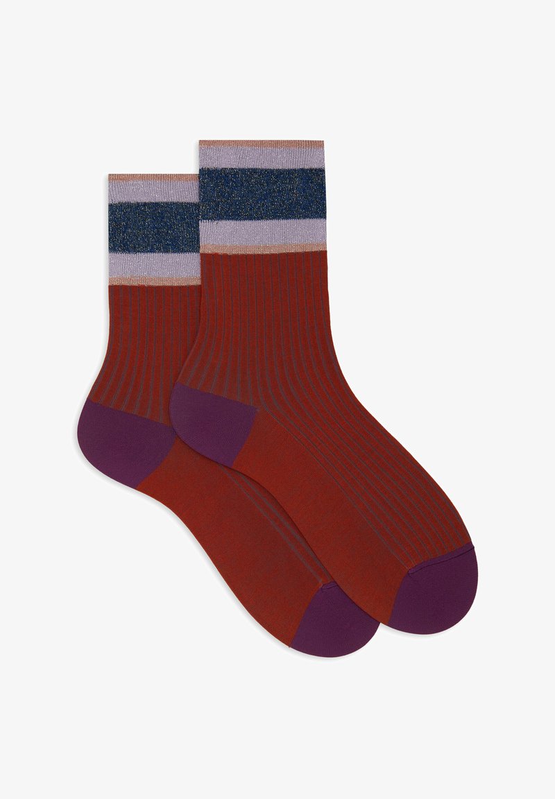 Ribbed socks in rust red with purple accent at the toe and cuff. Features three horizontal bands: navy, light purple, and metallic.