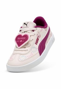 Sneakers Puma con una toma superiore sintetica di un rosa chiaro e accenti viola. Presentano un'etichetta a forma di cuore con la scritta "Hello Kitty e Friends" e disegni cartoon.