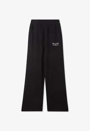 Pantaloni della tuta larghi neri realizzati in tessuto morbido, con vita elastica e tasche laterali, con la scritta ricamata "Beverly Hills California".