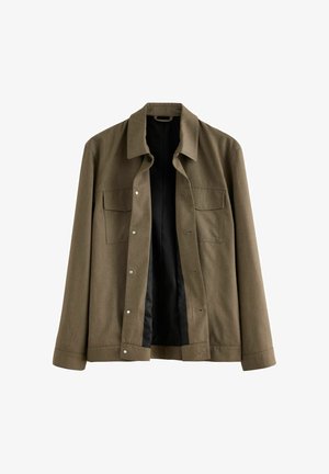 Hnědá bunda vyrobená z texturované látky, s špičatým límcem, zapínáním na knoflíky a dvěma náprsními kapsami. Uvnitř je hladká černá podšívka.