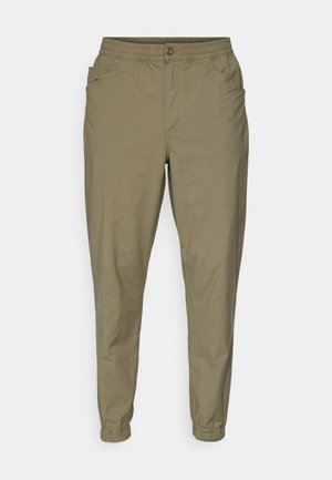 Light olive green pants with an elastic waistband, button closure, side pockets, and tapered legs with elastic cuffs. Soft, smooth fabric.