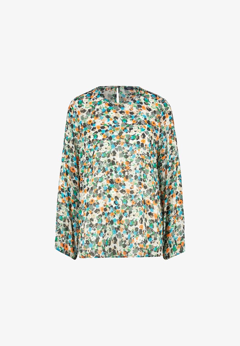 Blusa floral hecha de un tejido ligero y transparente; presenta un patrón multicolor con flores verdes, naranjas y azules sobre un fondo crema.