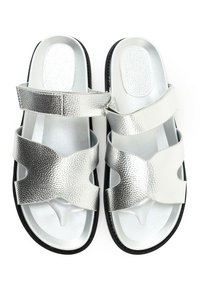 Silver sandals with two wide textured straps, a smooth footbed, and a black sole. The upper has a metallic finish and cut-out design.