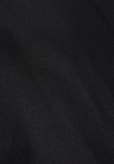 Close-up of black textured fabric with a fine woven pattern, showing subtle variations in light and shadow.