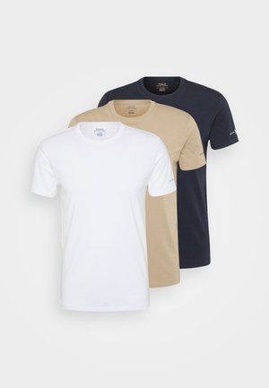 Three short-sleeve t-shirts in white, beige, and navy. Made of cotton with a smooth texture. Classic crew neck design with no patterns.