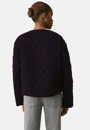 Quilted purple jacket in a cropped design with round neck and textured pattern. Features long sleeves and minimalistic back detail.