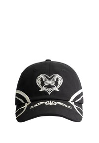 Black cap with white decorative embroidery featuring a heart and butterfly design. Accented with white stripes along the visor. Cotton material.