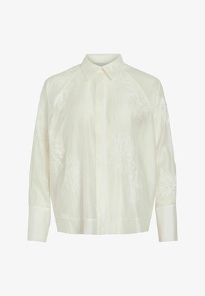 Chemise boutonnière ivoire clair avec motifs floraux brodés, manches longues et col classique. Texture lisse et coupe décontractée.