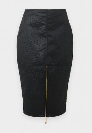 Black textured pencil skirt with raised dot pattern and central gold zipper running vertically from hem to waist.