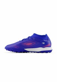 Blue athletic shoe with a textured upper, featuring pink accents and a low-cut collar. The sole has prominent traction nubs for grip.