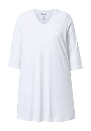 Biała tunika z dekoltem w kształcie litery V i rękawami do połowy przedramienia, wykonana z miękkiej bawełnianej tkaniny.