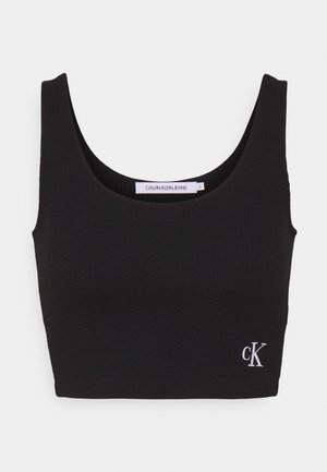 Zwart geribbeld cropped topje met brede schouderbanden, U-vormige halslijn en een klein wit "ck" logo linksonder. Zachte, aansluitende textuur.