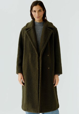 Olive green, long teddy coat with large collar, two button closure, and relaxed fit. Soft, textured fabric with a cozy appearance.