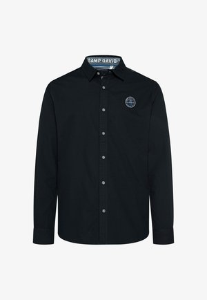 Camicia nera a maniche lunghe con bottoni, caratterizzata da un colletto punta, un piccolo logo sul petto e un bordino interno del colletto decorato. Tessuto in cotone.