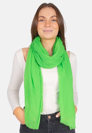 Green, lightweight scarf with a crinkled texture, draped loosely around the neck. Edges are frayed, adding subtle detail.