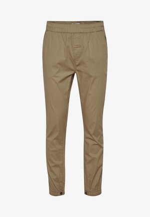 Pantaloni de culoare bej deschis, cu croi tapered, dotati cu un elastic la talie si inchideri cu nasturi la glezne. Acestia sunt realizati dintr-un material neted, avand un design minimalist.
