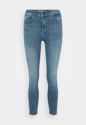 Skinny jeans in light blue denim, featuring a mid-rise waist, classic five-pocket design, and subtle fading throughout.