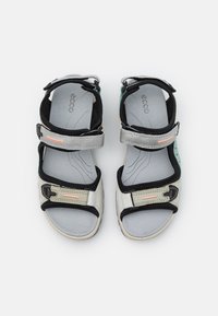 Gray and black open-toe sandals with Velcro straps. Soft inner lining, light gray footbed, and details in black and orange accents.