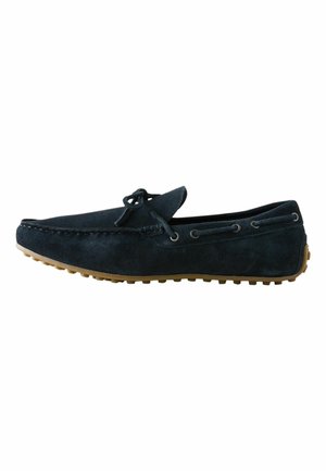 Black suede driving loafer with moccasin stitching, lace detail, and rubber studded sole, shown from the side on white background.