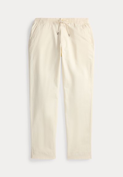 Light beige cotton trousers with an elastic waistband, drawstring, side pockets, and a relaxed fit. Smooth texture, versatile design.