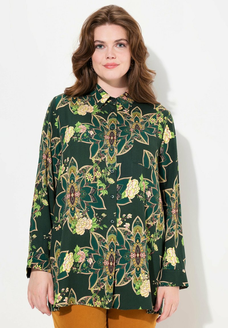 Green floral patterned blouse featuring a collar, long sleeves, and button closure. Notable details include intricate designs and rich colors.