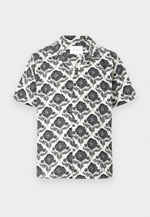 Cămașă cu mâneci scurte, cu un model floral negru pe fundal crem, având guler și croială lejeră.