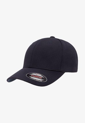 Navy blue baseball cap made of textured fabric with a curved visor. Features a Flexfit logo sticker on the front.