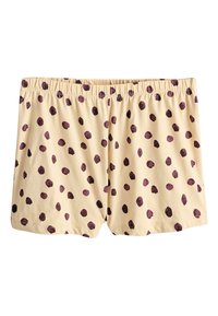 Shorts couleur crème avec ceinture élastique, décorés de pois irréguliers violet foncé répartis uniformément sur le tissu.