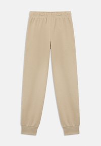 Μπεζ φόρμες με ελαστική μέση και ριμπ μανσέτες. Μαλακό, λείο ύφασμα με άνετη εφαρμογή, με ελάχιστα ραφές.