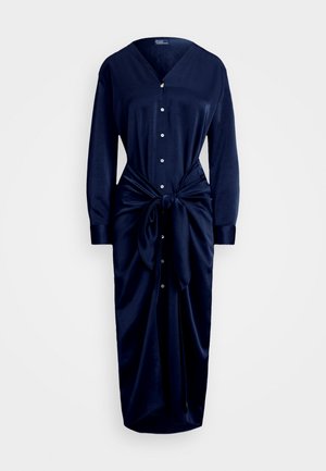 Vestido azul marinho feito de tecido suave, com decote em V, frente com botões, mangas longas e detalhe de cintura ajustada com uma saia fluida.