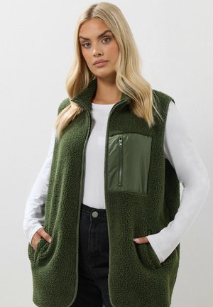 Olijfgroen fleece vest met een glanzende groene nylon ritszak, twee voorkanten en een ontwerp met hoge kraag. Geweven stof.