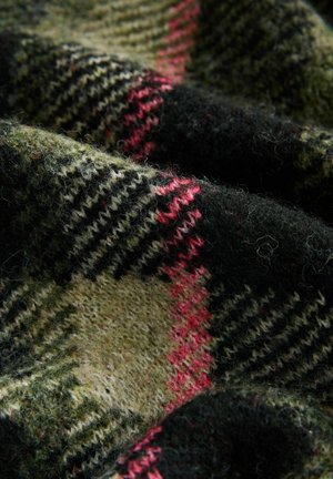 Close-up of textured wool fabric with a green, black, and red plaid pattern, showing detailed fibers and knit stitches.