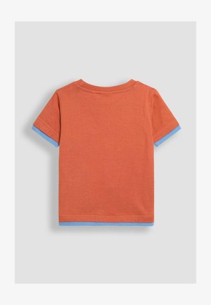 Trumpas rankovėmis marškinėliai iš oranžinės medvilnės su kontrastingais mėlynais apvadais ant rankovių. Minkšta, vientisa tekstūra, su apvaliu kaklu ir tiesia siluetu.