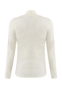 Langärmliges, geripptes Polo-Shirt in zartem Cremeton mit umschlagbarem Kragen. Glatte Textur, figurbetonte Silhouette und abgerundeter Saum.